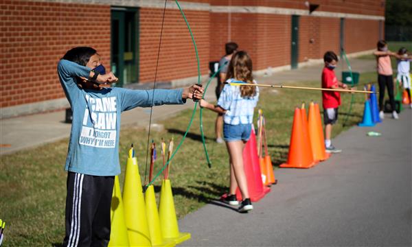 Students prepare to fire arrows